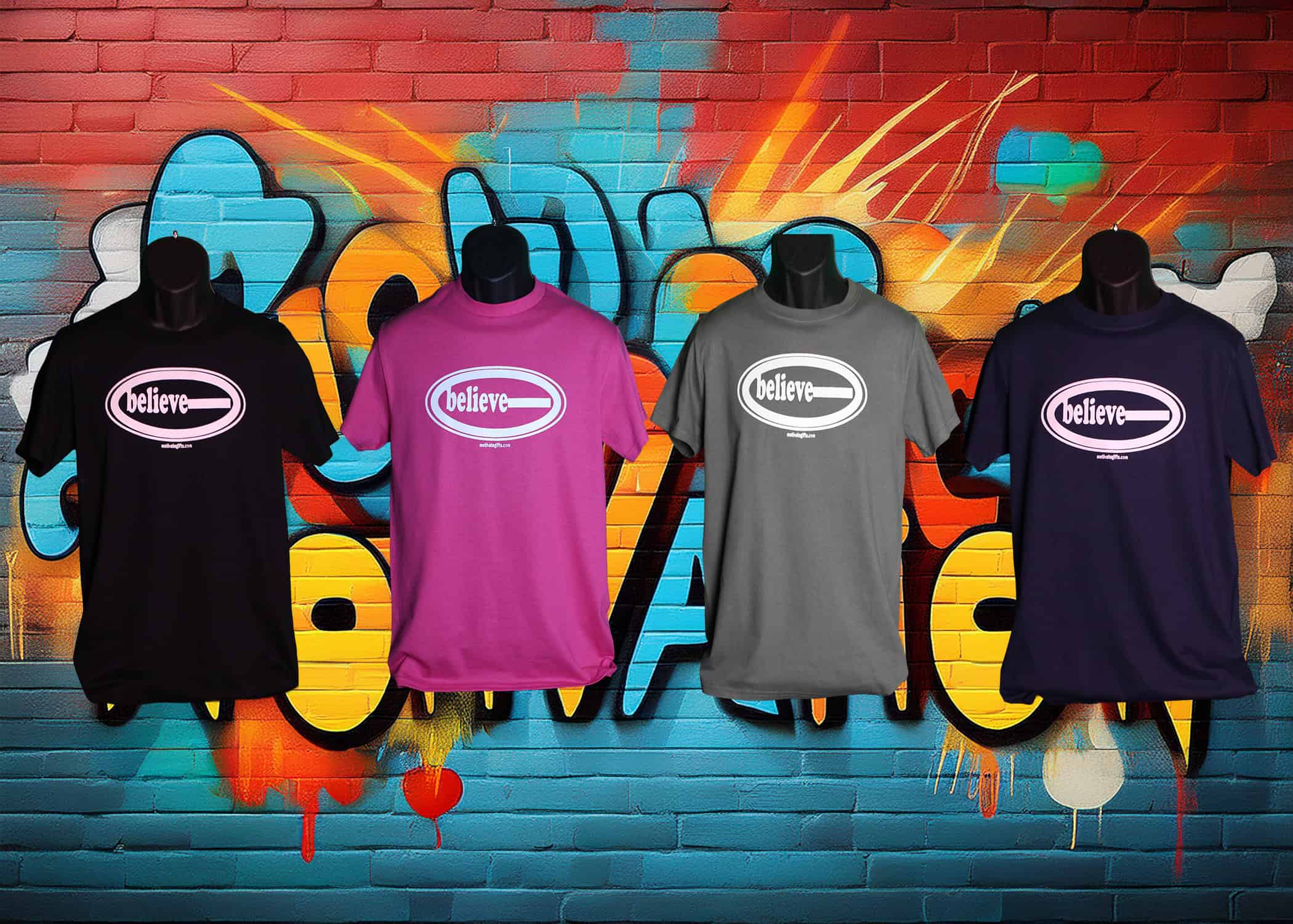Black T-Shirt With Believe written on the front in White ink. With motivategifts.com located bottom center.